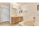 Bathroom with vanity and sink next to a soaking tub at 125 Vervain Ave, Davenport, FL 33837