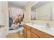 Bathroom with a double vanity, tile flooring, and a unique shower curtain at 125 Vervain Ave, Davenport, FL 33837