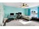 Bedroom featuring blue walls, carpeted floors, and a ceiling fan, providing comfort and style at 125 Vervain Ave, Davenport, FL 33837