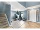 Foyer features wood-look floors, a staircase, high ceilings, and ample natural light from a front window at 125 Vervain Ave, Davenport, FL 33837