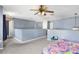 Spacious upstairs loft offers versatile living space with neutral carpet and light blue walls at 125 Vervain Ave, Davenport, FL 33837