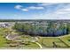 Aerial view of community featuring a scenic lake, playground, walking trails, and a fenced-in dog park at 13081 Sunrise Harvest Dr, Winter Garden, FL 34787