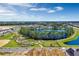 Beautiful aerial view of community lake, dog park, trails, and new home construction, perfect for modern living at 13081 Sunrise Harvest Dr, Winter Garden, FL 34787
