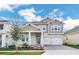 Inviting two-story home with a two-car garage, brick paved driveway, and front landscaping at 13081 Sunrise Harvest Dr, Winter Garden, FL 34787