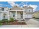 Charming two-story home with a well-manicured front yard and a two-car garage at 13081 Sunrise Harvest Dr, Winter Garden, FL 34787