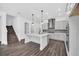 Open kitchen featuring a quartz island, stainless steel appliances, and modern light fixtures at 13081 Sunrise Harvest Dr, Winter Garden, FL 34787