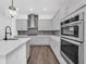 Close up on the kitchen with gray cabinets and new stainless steel appliances at 13081 Sunrise Harvest Dr, Winter Garden, FL 34787