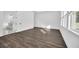 Open bedroom with modern en suite bathroom and wood-look floors at 13081 Sunrise Harvest Dr, Winter Garden, FL 34787