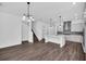Spacious open-concept floor plan with kitchen island, gray cabinets and stainless steel appliances at 13081 Sunrise Harvest Dr, Winter Garden, FL 34787