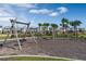 Playground features swings and climbing structures, surrounded by lush landscaping at 13081 Sunrise Harvest Dr, Winter Garden, FL 34787