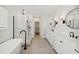 Bright bathroom with double sinks, sleek fixtures, walk-in shower and soaking tub at 13175 Telsen St # 40, Winter Garden, FL 34787
