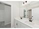 Contemporary bathroom featuring a dual sink vanity with modern fixtures and an expansive mirror at 13175 Telsen St # 40, Winter Garden, FL 34787