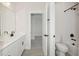 Bright bathroom featuring double vanity, tub, shower, and toilet in a modern, stylish design at 13175 Telsen St # 40, Winter Garden, FL 34787