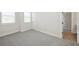 Spacious bedroom showcasing plush carpet, two bright windows, and a doorway leading to the bathroom at 13175 Telsen St # 40, Winter Garden, FL 34787