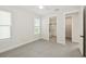 A sunlit bedroom showcasing neutral tones, with an en-suite bathroom and walk-in closet for added convenience at 13175 Telsen St # 40, Winter Garden, FL 34787