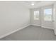 Bright bedroom with neutral walls, plush carpet, and two bright windows at 13175 Telsen St # 40, Winter Garden, FL 34787