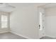 Bedroom with stylish, modern flooring, natural light, and adjacent room with white paneled accent wall at 13175 Telsen St # 40, Winter Garden, FL 34787