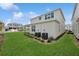 Well-maintained backyard showing manicured lawn and landscaping, complemented by the building's contemporary exterior at 13175 Telsen St # 40, Winter Garden, FL 34787