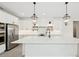 Spacious white kitchen featuring an island with quartz countertops, and stainless steel appliances at 13175 Telsen St # 40, Winter Garden, FL 34787