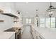 Modern kitchen featuring an island, stainless steel appliances, and open shelves at 13175 Telsen St # 40, Winter Garden, FL 34787