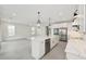 Bright kitchen featuring stainless steel appliances, an island with sink, and pendant lighting at 13175 Telsen St # 40, Winter Garden, FL 34787