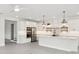 Bright kitchen featuring white cabinetry, stainless steel appliances, and pendant lighting over the island at 13175 Telsen St # 40, Winter Garden, FL 34787
