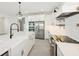 Elegant kitchen featuring stainless steel appliances, an island, and pendant lights at 13175 Telsen St # 40, Winter Garden, FL 34787