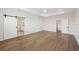 Spacious main bedroom featuring hardwood flooring, tray ceiling and barn door access to bathroom at 13175 Telsen St # 40, Winter Garden, FL 34787