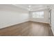 Large main bedroom featuring wood flooring, paneled accent wall and a bright window at 13175 Telsen St # 40, Winter Garden, FL 34787