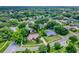 An elevated aerial view of a residential neighborhood with mature trees, landscaping, and well-maintained streets at 1390 Yellow Pine Ct, Winter Springs, FL 32708