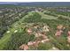 Scenic aerial view showcasing a golf course community, blending residential living with recreational green spaces at 1390 Yellow Pine Ct, Winter Springs, FL 32708