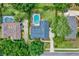 Aerial view showcasing a backyard pool, mature trees, and a well-maintained property in a serene setting at 1390 Yellow Pine Ct, Winter Springs, FL 32708