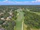 Expansive aerial view of a lush golf course winding through a scenic residential area, dotted with trees at 1390 Yellow Pine Ct, Winter Springs, FL 32708