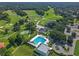Aerial view of the community pool, clubhouse, golf course, and surrounding greenery offering resort-style living at 1390 Yellow Pine Ct, Winter Springs, FL 32708