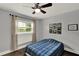 Bedroom with wood flooring, ceiling fan, and window with a view of the outdoors at 1390 Yellow Pine Ct, Winter Springs, FL 32708