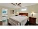 Charming bedroom features a ceiling fan, dark hardwood floors, and an en suite bathroom at 1390 Yellow Pine Ct, Winter Springs, FL 32708