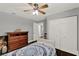 Cozy bedroom features a ceiling fan, dark wood floors and a double door closet at 1390 Yellow Pine Ct, Winter Springs, FL 32708
