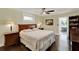 Cozy bedroom featuring wood floors, ceiling fan, and a comfortable-looking bed with patterned bedding at 1390 Yellow Pine Ct, Winter Springs, FL 32708