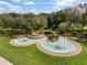 Scenic entrance to the community featuring a tiered fountain, lush landscaping, and a welcoming sign at 1390 Yellow Pine Ct, Winter Springs, FL 32708