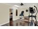 Bright exercise room features ceiling fan and access to bedroom with dark hardwood floors at 1390 Yellow Pine Ct, Winter Springs, FL 32708