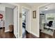 Hallway showcases hardwood flooring and views into the bedroom and office at 1390 Yellow Pine Ct, Winter Springs, FL 32708