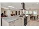 Kitchen with granite countertops, stainless steel appliances, and adjacent dining and living spaces at 1390 Yellow Pine Ct, Winter Springs, FL 32708