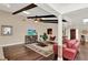 The cozy living room features beamed ceiling, hardwood floors, and a comfortable seating area at 1390 Yellow Pine Ct, Winter Springs, FL 32708