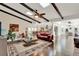 Open floor plan features wood floors, beamed ceilings, and flows seamlessly from the living room to the kitchen at 1390 Yellow Pine Ct, Winter Springs, FL 32708