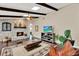 Comfortable living room features stone fireplace, wood floors, beamed ceiling, and a ceiling fan at 1390 Yellow Pine Ct, Winter Springs, FL 32708
