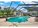 An inground swimming pool is surrounded by beautiful landscaping and patio furniture at 1390 Yellow Pine Ct, Winter Springs, FL 32708