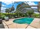 An inground swimming pool is surrounded by beautiful landscaping and patio furniture at 1390 Yellow Pine Ct, Winter Springs, FL 32708