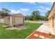 Large backyard with a storage shed, privacy fence, and well-manicured lawn at 1395 Deland Ave, Orange City, FL 32763