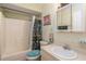 Cozy bathroom featuring a shower, toilet, and single sink vanity with decorative mirror at 1395 Deland Ave, Orange City, FL 32763