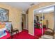 A charming bedroom featuring red carpet and a convenient closet with sliding mirror doors at 1395 Deland Ave, Orange City, FL 32763